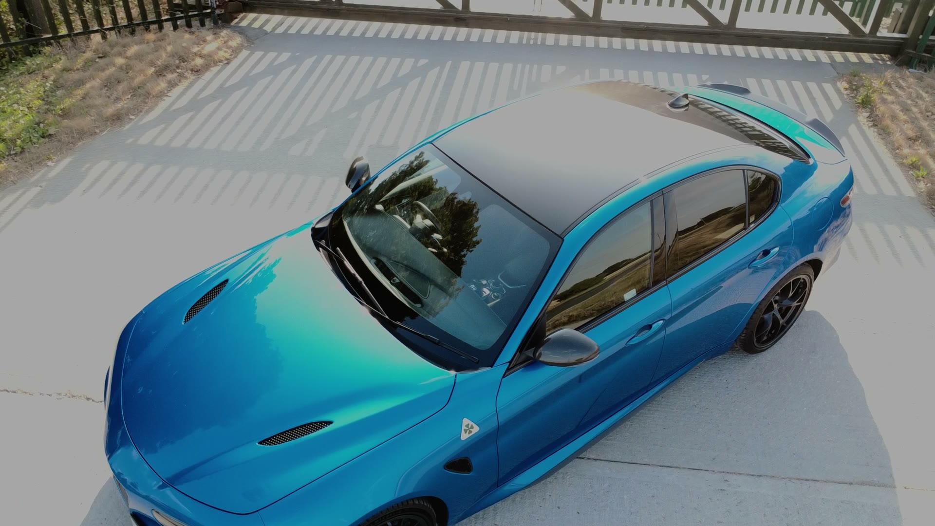 Blue Alfa Romeo car filmed for a promotional video