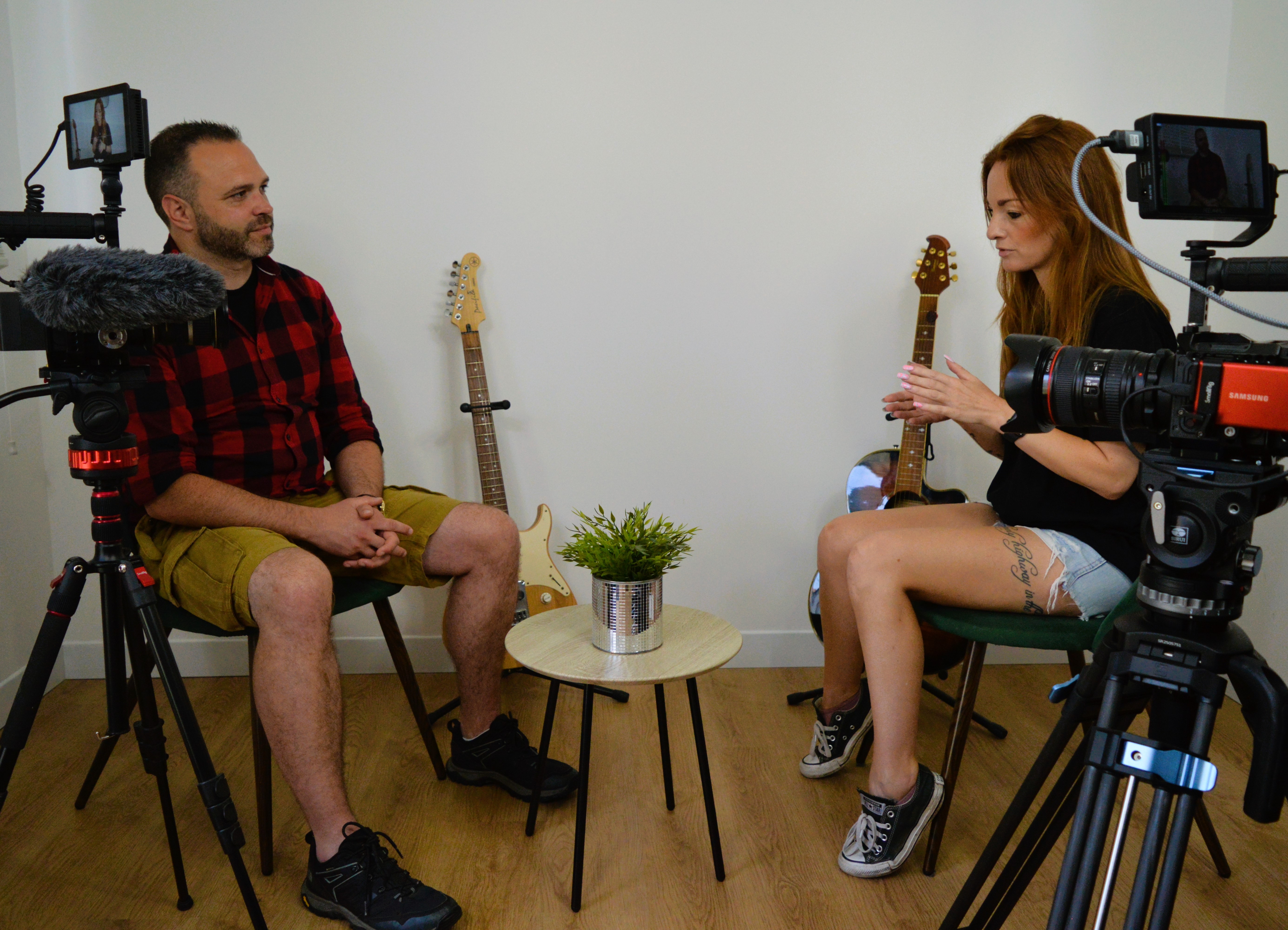Podcast studio two people seated for recording